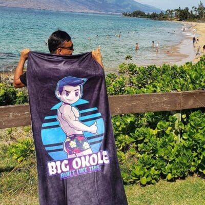 A person holding up a towel with the words " big ohole " on it.